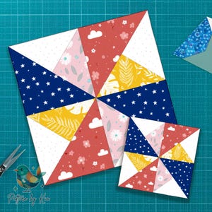 Puede incluir: Dos bloques de edredón de molinillo de viento coloridos. El bloque más grande presenta triángulos de azul marino con estrellas blancas, amarillo con hojas tropicales, rojo con nubes y flores blancas y blanco con pequeños puntos. Un bloque más pequeño está al lado. El texto "Pattern by Kia" está en la esquina.