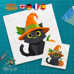 May include: A paper piecing quilt pattern featuring a black cat wearing an orange witch hat with a green band and leaf detail. The cat has large yellow eyes and sits next to an orange pumpkin. The design is set against a white background.