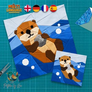 May include: A foundation paper piecing quilt block pattern featuring a brown otter floating in blue water, holding a grey rock. The design includes white geometric bubbles, with the text MULTI LANGUAGE and four flag icons at the top, and a bird logo.