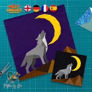May include: A fabric quilt block pattern featuring a geometric grey wolf howling at a bright yellow crescent moon against a dark purple sky, with brown mountain peaks at the bottom, accompanied by a smaller version on a black background.