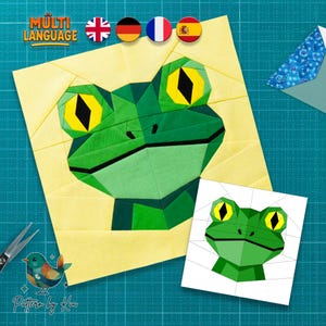 May include: A geometric frog design in shades of green, yellow, and black, set against a yellow background. The image includes the text "MULTI LANGUAGE" and a smaller frog illustration. A pair of scissors and a bird logo are also visible.