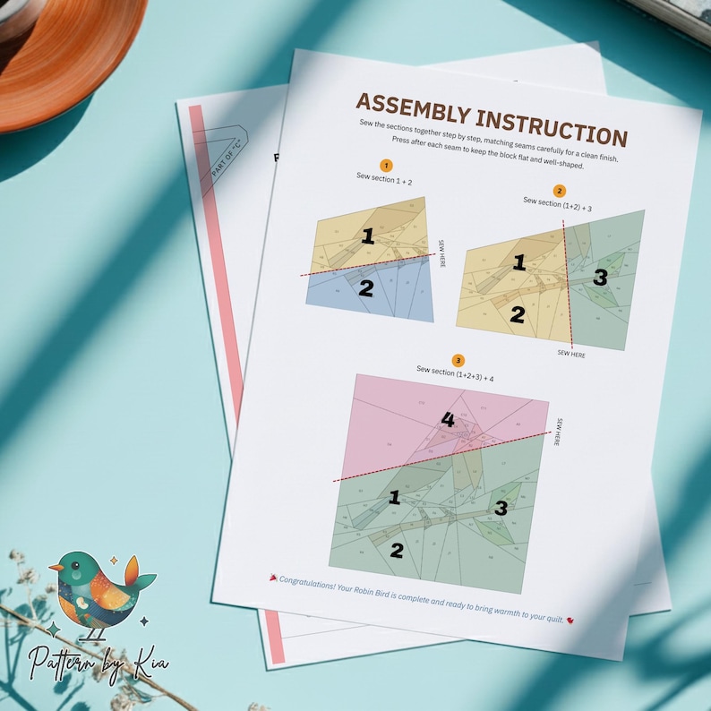 May include: Assembly instruction sheets for a quilt project. The instructions show diagrams with numbered sections and the text "Sew section" with diagrams. The sheets are on a light blue surface with a decorative bird illustration.