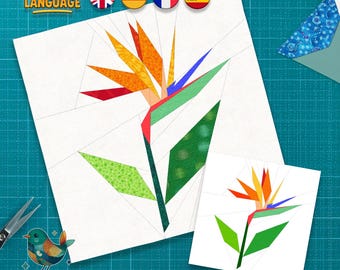 Puede incluir: Un patrón de costura en papel de una flor de ave del paraíso en tonos naranja, amarillo, verde, rojo y azul. La imagen incluye el texto "MULTI LANGUAGE" y "Pattern by Kia". También se ven unas tijeras y una pequeña ilustración de un pájaro.