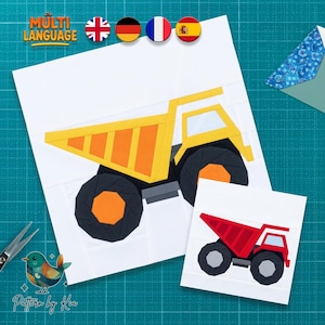 May include: A paper craft pattern featuring a large yellow and orange dump truck on a white sheet, alongside a smaller red and gray dump truck pattern. The design includes geometric shapes and bold colors, presented as a printable template for crafting.