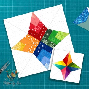 May include: Two star-shaped quilt blocks, one large and one small, with a rainbow of colors in the star points. The larger block is on a white background with a dotted pattern. The smaller block is a miniature version of the larger one. The background is a teal cutting mat.