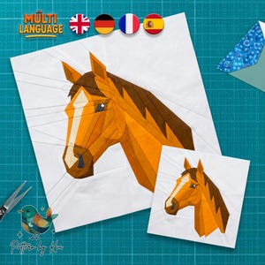 May include: Two white squares with a geometric horse head design in shades of brown and orange. The larger square has the text "Pattern by Kiu" and "MULTI LANGUAGE" in the upper left corner. A pair of scissors and a bird graphic are also visible.