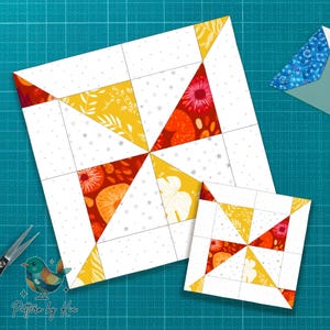 Puede incluir: Dos bloques de edredón con un diseño de molinillo. El bloque más grande es blanco con líneas de cuadrícula gris y presenta triángulos de patrones florales amarillos, naranjas y rojos. El bloque más pequeño refleja el diseño. Unas tijeras y un logotipo de pájaro están en la imagen.