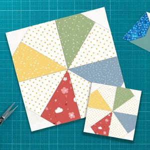 Può includere: Due blocchi di trapunte colorati con un design a girandola. Il blocco più grande presenta triangoli gialli, verdi, blu e rossi con pois bianchi e motivi floreali. Una versione più piccola è accanto. Sono visibili anche forbici e una busta.