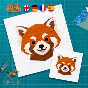 May include: Two white fabric squares with geometric red panda designs. The larger square features a detailed red panda face, while the smaller square displays a simplified version. The image includes the text "MULTI LANGUAGE" and flags.