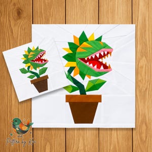 May include: A foundation paper piecing quilt block pattern featuring a carnivorous plant in a brown pot. The plant has green and yellow leaves, a red mouth with white teeth, and pink lips. A smaller version of the same design is layered on top.
