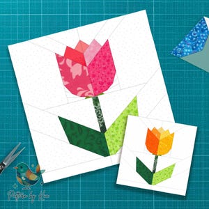 May include: Two paper piecing patterns of tulips. The larger tulip has a pink and red flower with green leaves and a patterned stem. The smaller tulip has an orange and yellow flower with green leaves and a stem. The background is white with a dotted pattern.
