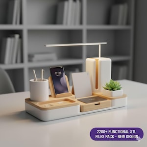May include: A white and bamboo desk organiser with a built-in lamp, phone stand, and small succulent plant. The phone displays 17:26. The text "2200+ FUNCTIONAL STL FILES PACK - NEW DESIGN" is in a purple oval.