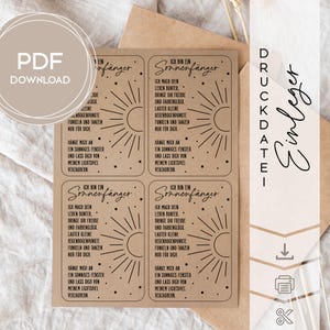 May include: A set of four rectangular cards with a sunburst design and German text. The cards are printed on a light brown paper, with the words "PDF DOWNLOAD" in a circle in the upper left corner. The cards are designed to be used as inserts.