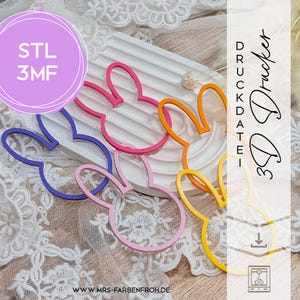 Könnte beinhalten: Eine Sammlung farbenfroher Hasen-Ausstecher in Rosa, Orange, Gelb, Lila und Blau. Das Bild enthält den Text "STL 3MF" in einem lila Kreis und "3D Drucker Druckdatei" in schwarzer Schrift. Die Website-Adresse ist ebenfalls sichtbar.