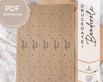 May include: Kraft paper printable Advent calendar bands with black text and star and dot patterns. The bands read "Advent to go." The words "PDF Download" are in a circle in the upper left corner. The words "Druckdatei Banderole" are on the right side.