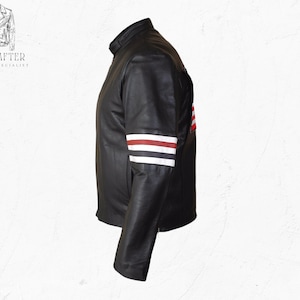 May include: Black leather jacket with a stand-up collar and a design on the sleeve featuring red and white stripes. The jacket has a classic motorcycle style. The brand name "MR KRAFTER LEATHER SPECIALIST" is visible in the upper left corner.