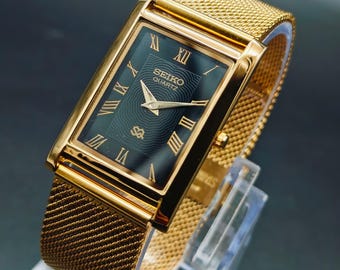 Reloj de pulsera vintage Seiko Slim Tank de cuarzo para hombre, esfera rectangular negra.