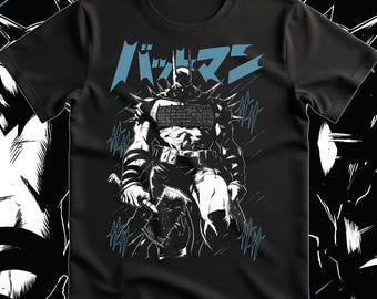 May include: A black short-sleeved t-shirt featuring a graphic print of a comic book character in a spiked suit holding an axe. The design includes blue Japanese text at the top and blue stylized slash marks surrounding the figure, set against a black background.