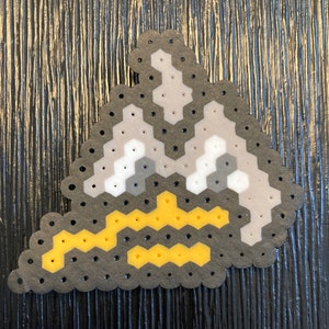 May include: A grey and white pixel art mountain with a yellow pixel art lightning bolt at the bottom.