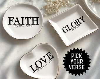 May include: White ceramic trinket dishes in round, square, and heart shapes. Each dish has a gold rim and a black word: "FAITH", "GLORY", and "LOVE". The dishes also have Bible verses. A black and white "PICK YOUR VERSE" sticker is included.