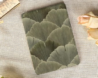 May include: A rectangular, olive green decorative tray featuring a repeating pattern of stylized ginkgo leaves. The leaves have a textured appearance with subtle shading, creating a sense of depth and dimension. The tray is surrounded by flowers and a vintage-style letter.