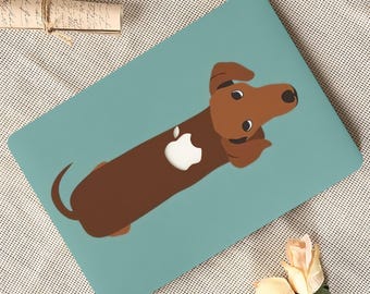 May include: A brown dachshund dog illustration with a white apple logo on a teal laptop skin. The dog is lying down, with its head and paws visible. The background is a light teal color.