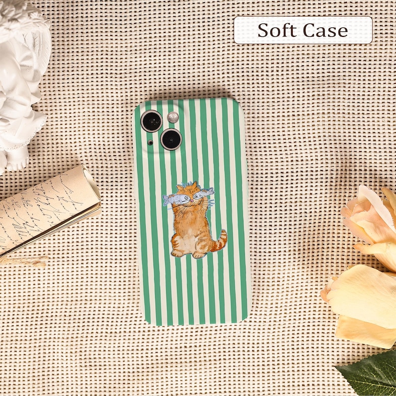 May include: A green and white striped phone case featuring an orange cartoon cat holding fish. The case is a soft case design. The text "Soft Case" is displayed at the top.