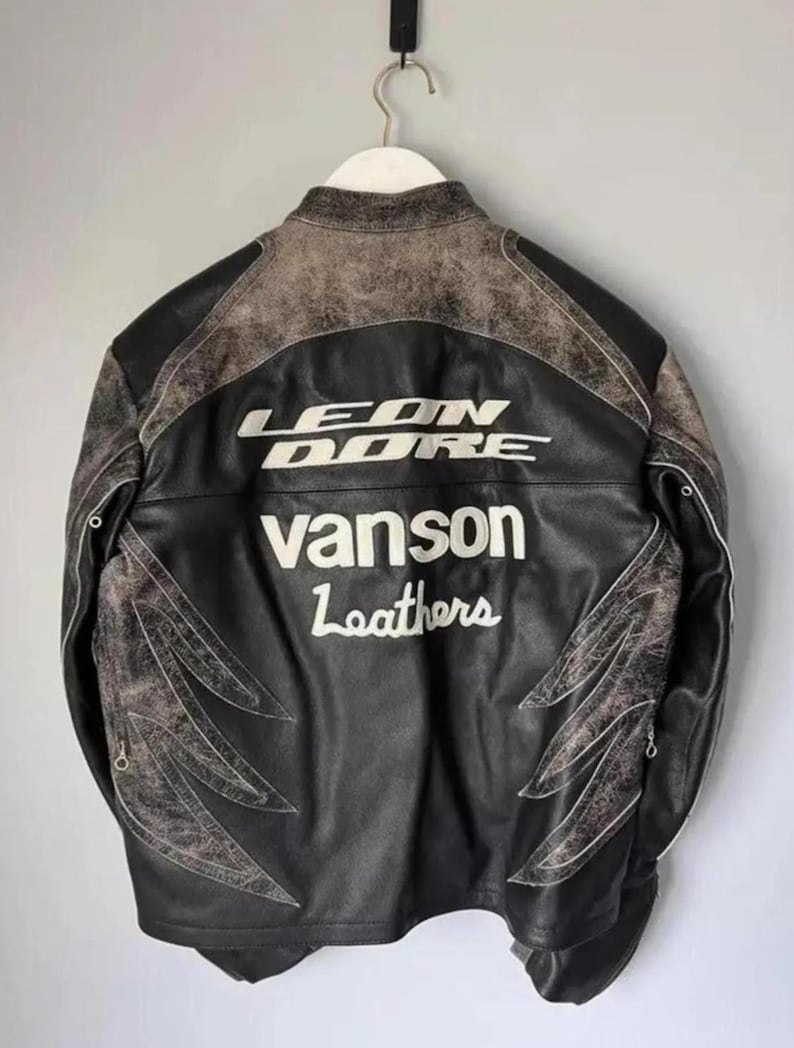 May include: Black leather jacket with the text "LEON DORE" and "Vanson Leathers" in white. The jacket has distressed brown accents on the shoulders and decorative stitching.