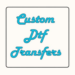 May include: A white square with a black border features the words "Custom Dtf Transfers" in a teal, cursive font. The text is centered on the square, creating a clean and simple design.