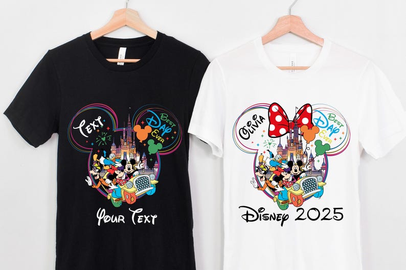 May include: Two t-shirts, one black and one white, each featuring a colorful Disney-themed graphic. The black shirt has the text "Your Text" and the white shirt says "Disney 2025". Both shirts have a Mickey Mouse head design with Disney characters.