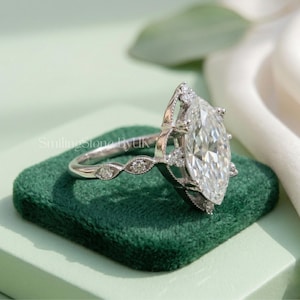 Profile view of an intricate 10k solid gold custom promise ring with a 1.8mm thin milgrain band. The high profile cathedral setting elevates the timeless heirloom piece. Personalized ornate filigree detail set showcases quiet luxury aesthetic. Perfect romantic era piece, antique style band, high profile gem, handmade bespoke jewelry, unique statement, and travel safe jewelry.