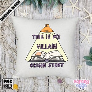 May include: Square off-white throw pillow with the text "THIS IS MY VILLAIN ORIGIN STORY" in purple, with a cartoon illustration of a book under a spotlight. The pillow has a digital download label.
