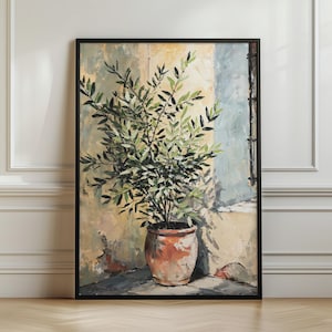May include: A framed vertical wall art print depicting an olive tree in a terracotta pot set against a textured, sunlit wall. The painting features shades of green, beige, and soft blue, with visible brushstrokes capturing light and shadow.