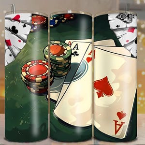 May include: A tumbler with a poker theme, showing playing cards, poker chips, and the Ace of Spades and Ace of Hearts. The background is a green felt table. The tumbler has a silver straw.