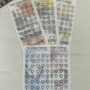 May include: Five clear cards with heart outlines, each labelled with a dollar challenge amount. The cards are labelled "Twenty Dollar Challenge", "Fifty Dollar Challenge", "One Hundred Dollar Challenge", "Ten Dollar Challenge", and "Dollar Challenge".