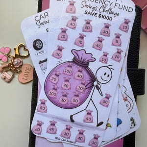 May include: A white paper savings challenge tracker featuring the text EMERGENCY FUND Savings Challenge SAVE $1000. The design includes a stick figure carrying a large purple sack filled with smaller pink money bags, each labelled with currency amounts.