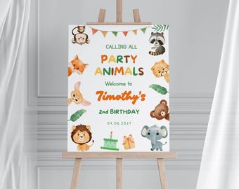 May include: A white sign on a wooden easel with the text "Calling All Party Animals" and "Welcome to Timothy's 2nd Birthday". The sign features watercolor illustrations of various animals, including a monkey, fox, raccoon, and lion.
