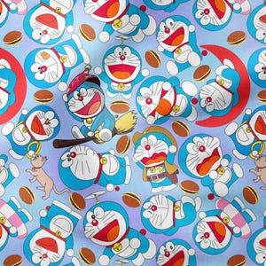 May include: A repeating pattern featuring the cartoon character Doraemon in various poses. The design includes Doraemon in blue, white, and red, along with brown cookies and a red crescent moon on a light blue background.