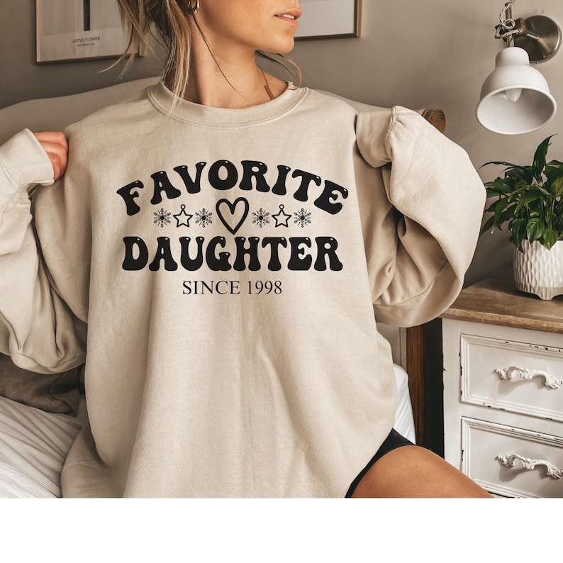 May include: A set of three ceramic mugs with a speckled, matte finish. The mugs are in shades of cream, light gray, and dark gray. Each mug has a simple, minimalist design, perfect for coffee or tea.