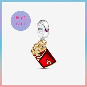 May include: A silver Pandora charm with a red and gold envelope design. The charm features a red enamel envelope with gold accents and a small, clear gemstone. The charm has the text "Pandora" on the silver loop.