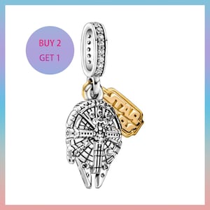 May include: A silver charm featuring the Millennium Falcon, a gold-coloured Star Wars logo, and a silver loop set with clear stones. The image includes a purple circle with the text "BUY 2 GET 1".