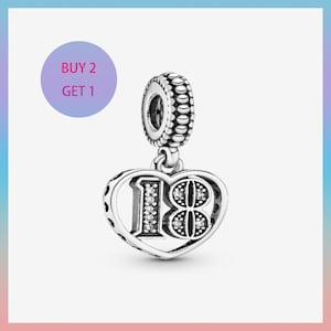 May include: A silver charm with a heart-shaped pendant featuring the number "18" embellished with clear crystals. The charm has a beaded top and a small loop for attachment. A purple circle with the text "BUY 2 GET 1" is in the upper left corner.