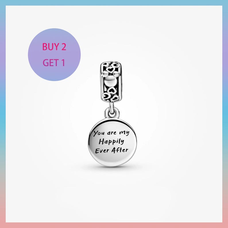 May include: A silver charm with a decorative top and a round pendant. The pendant is engraved with the words "You are my Happily Ever After". The charm is suspended from a decorative bail. The image also includes a purple circle with the text "BUY 2 GET 1".