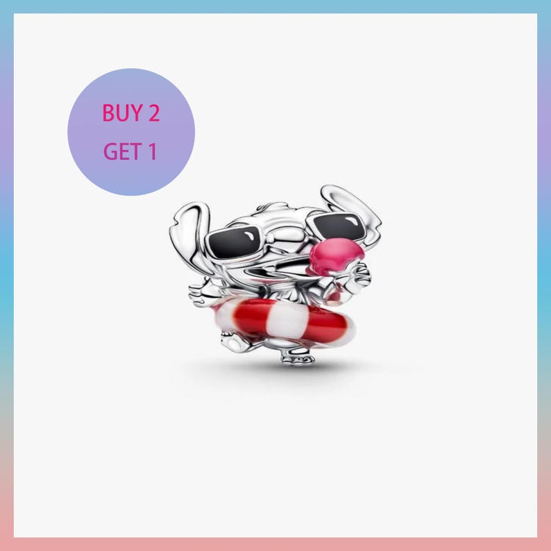 May include: A silver charm featuring the character Stitch from Lilo & Stitch, wearing sunglasses and holding a red and white striped life preserver. The charm has a pink ice cream cone. A purple circle with the text "BUY 2 GET 1" is in the background.