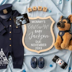 May include: A navy blue baby police officer outfit with a matching hat, ultrasound image, and a sign that reads "Mommy's Cutest Case Yet! Baby Jackson Due: November 20XX." Also included are blue shoes, a plush police dog, and a toy police car.