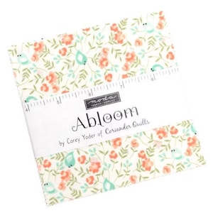 May include: A stack of fabric squares with a floral pattern featuring peach flowers, teal birds, and green leaves on a cream background. The fabric is labeled "Abloom" by Corey Yoder of Coriander Quilts.