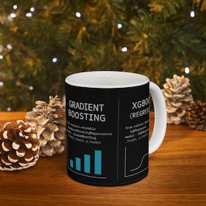 May include: White ceramic mug with a black background featuring the words "GRADIENT BOOSTING" and "XGBOO (REGRESS)" in white text. The mug also displays a bar graph and a line graph in teal. The mug is on a wooden surface.