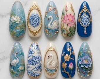 May include: A set of ten almond-shaped press-on nails featuring intricate 3D designs. The collection includes motifs of white swans, pink lotus flowers, blue and white clouds, cranes, and ornate gold frames on cream, light blue, and deep blue bases.