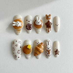 May include: A set of three ceramic mugs with a speckled, matte finish. Each mug features a different color: light blue, cream, and gray. The mugs have a simple, modern design and a comfortable handle.