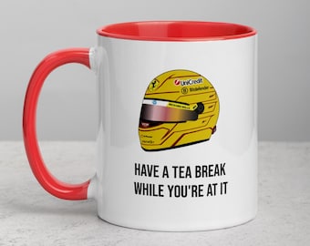 May include: White ceramic mug with a red interior and handle. The mug features a yellow racing helmet design with sponsor logos and the text "HAVE A TEA BREAK WHILE YOU'RE AT IT".